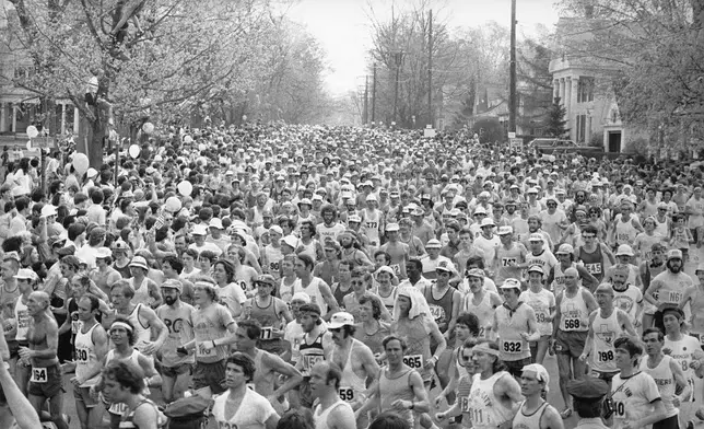 FILE - Runners begin their dash from Hopkinton, Mass., to Boston on April 19, 1976 in the 80th annual Boston Marathon Once a year for the last 100 years, Hopkinton becomes the center of the running world, thanks to a quirk of geography and history that made it the starting line for the world's oldest and most prestigious annual marathon. (AP Photo/File)