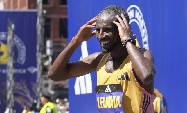 Sisay Lemma, of Ethiopia, celebrates after winning the Boston Marathon, Monday, April 15, 2024, in Boston. (AP Photo/Steven Senne)