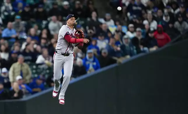 Atlanta Braves shortstop Orlando Arcia throws to second base for an out against Seattle Mariners' Cal Raleigh on a ball hit by Mariners' Ty France during the fifth inning of a baseball game Monday, April 29, 2024, in Seattle. (AP Photo/Lindsey Wasson)