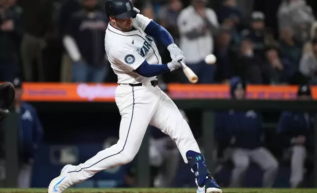 Seattle Mariners designated hitter Mitch Garver hits a two-run walk-off home run against the Atlanta Braves during the ninth inning of a baseball game Monday, April 29, 2024, in Seattle. The Mariners won 2-1. (AP Photo/Lindsey Wasson)