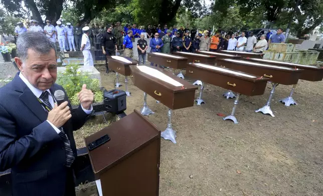 Federal police superintendent Jose Roberto Peres speaks during a burial service for nine unidentified migrants, at the Sao Jorge cemetery, in Belem, Para state, Brazil, Thursday, April 25, 2024. The bodies of nine migrants found on an African boat off the northern coast of Brazil's Amazon region were buried Thursday with a solemn ceremony. (AP Photo/Paulo Santos)