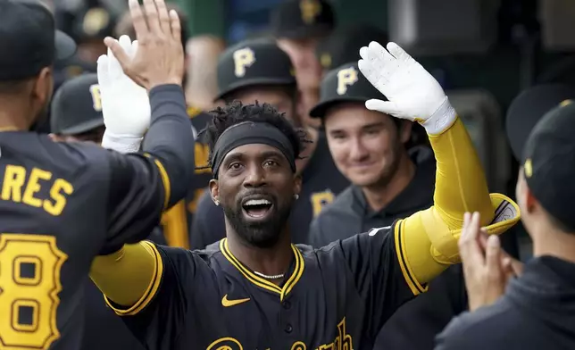 Pittsburgh Pirates' Andrew McCutchen celebrates in the dugout after hitting a home run against the Milwaukee Brewers during the first inning of a baseball game Tuesday, April 23, 2024, in Pittsburgh. (AP Photo/Matt Freed)