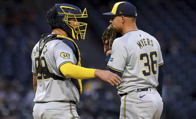 Milwaukee Brewers catcher Gary Sanchez, left, talks with starting pitcher Tobias Myers during the fourth inning of the team's baseball game against the Pittsburgh Pirates on Tuesday, April 23, 2024, in Pittsburgh. (AP Photo/Matt Freed)