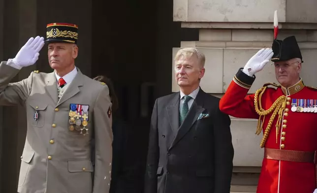 French Chief of the Army Staff, General Pierre Schill, left and Clive Alderton, Private Secretary to Britain's King Charles III and Queen Camilla, centre, watch as Scots Guards and troops from France's 1er Regiment de le Garde Republicaine partake in the Changing of the Guard ceremony at Buckingham Palace, to commemorate the 120th anniversary of the Entente Cordiale - the historic diplomatic agreement between Britain and France which laid the groundwork for their collaboration in both world wars, in London, Monday, April 8, 2024. France is the first non-Commonwealth country to take part in the Changing of the Guard. (Victoria Jones/Pool Photo via AP)