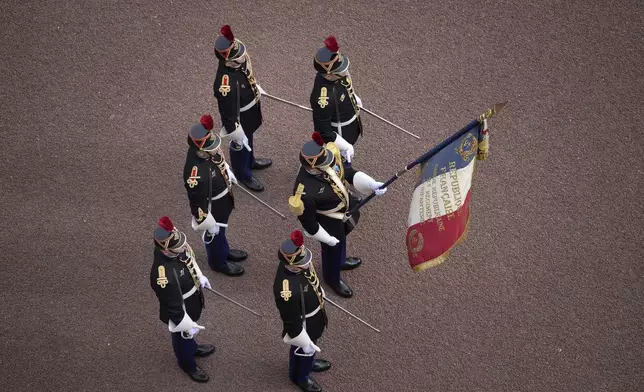 Troops from France's 1er Regiment de le Garde Republicaine partake in the Changing of the Guard ceremony at Buckingham Palace, to commemorate the 120th anniversary of the Entente Cordiale - the historic diplomatic agreement between Britain and France which laid the groundwork for their collaboration in both world wars, in London, Monday, April 8, 2024. France is the first non-Commonwealth country to take part in the Changing of the Guard. (Aaron Chown/PA via AP)
