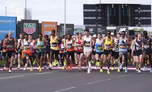 Runners including Tamirat Tola, Kenenisa Bekele and Norman Shreeve at the start of the men's elite race at the London Marathon, London, Sunday April 21, 2024. (Zac Goodwin/PA via AP)