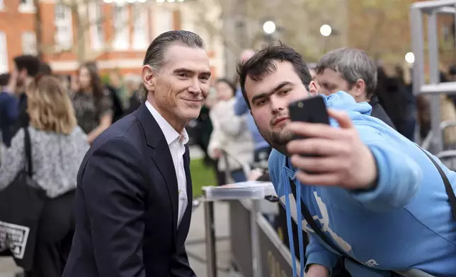 Billy Crudup, left, poses for a selfie upon arrival at the Olivier Awards on Sunday, April 14, 2024, in London. (Photo by Vianney Le Caer/Invision/AP)