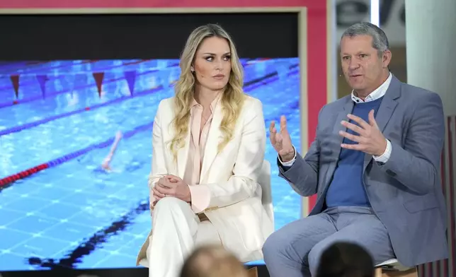 Lindsey Vonn, Olympic Skiing Champion and Christoph Schell Executive Vice President and Chief Commercial Officer, Intel Corporation, speak at the International Olympic Committee launch of the Olympic AI Agenda at Lee Valley VeloPark, in London, Friday, April 19, 2024. The IOC will be presenting the envisioned impact that artificial intelligence can deliver for sport, and how the IOC intends to lead on the global implementation of AI within sport. (AP Photo/Kirsty Wigglesworth)