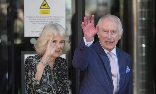 Britain's King Charles III and Queen Camilla wave as they arrive for a visit to University College Hospital Macmillan Cancer Centre in London, Tuesday, April 30, 2024. The King, Patron of Cancer Research UK and Macmillan Cancer Support, and Queen Camilla visited the University College Hospital Macmillan Cancer Centre, meeting patients and staff. This visit is to raise awareness of the importance of early diagnosis and will highlight some of the innovative research, supported by Cancer Research UK, which is taking place at the hospital. (AP Photo/Kin Cheung)