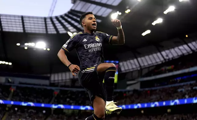 Real Madrid's Rodrygo celebrates scoring the opening goal, during the Champions League quarterfinal, second leg soccer match between Manchester City and Real Madrid, at the Etihad Stadium, in Manchester, England. Wednesday April 17, 2024. (Martin Rickett/PA via AP)