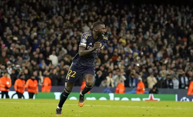 Real Madrid's Antonio Rudiger celebrates after scoring from the penalty spot during the Champions League quarterfinal second leg soccer match between Manchester City and Real Madrid at the Etihad Stadium in Manchester, England, Wednesday, April 17, 2024. (AP Photo/Dave Thompson)