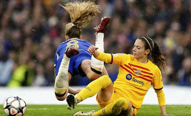 Chelsea's Melanie Leupolz, left, and Barcelona's Aitana, right, challenge for the ball during the Women's Champions League, semi final second leg, soccer match between FC Chelsea and FC Barcelona in London, England, Saturday, April 27, 2024. (Zac Goodwin/PA via AP)