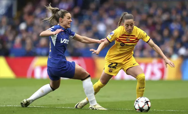 Barcelona's Ona Batlle, right, and Chelsea's Johanna Rytting Kaneryd, left, challenge for the ball during the Women's Champions League, semi final second leg, soccer match between FC Chelsea and FC Barcelona in London, England, Saturday, April 27, 2024. (Kieran Cleeves/PA via AP)