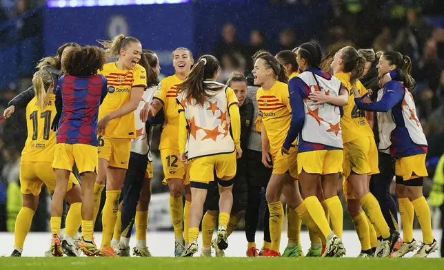 Barcelona's Fridolina Rolfo, fourth left, and her teammates celebrate after the Women's Champions League, semi final second leg, soccer match between FC Chelsea and FC Barcelona in London, England, Saturday, April 27, 2024. (Zac Goodwin/PA via AP)