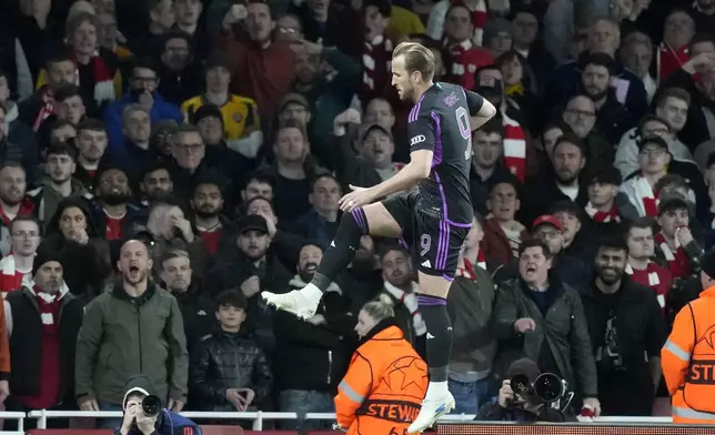 Bayern's Harry Kane celebrates after he scored his side's second goal from the penalty spot during the Champions League quarter final first leg soccer match between Arsenal and Bayern Munich at the Emirates Stadium, London, Tuesday, April 9, 2024. (AP Photo/Frank Augstein)