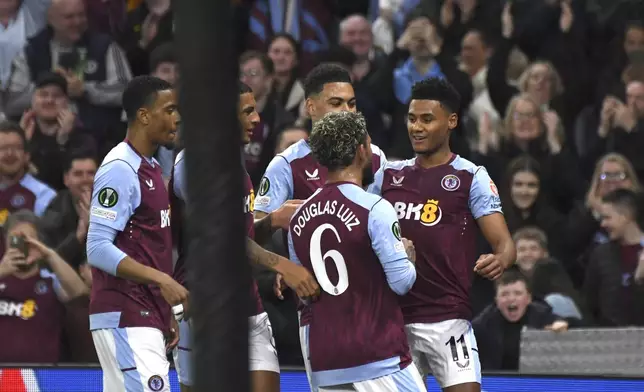 Aston Villa's Ollie Watkins, right, celebrates after scoring his side's opening goal during the Europa Conference League quarter final first leg soccer match between Aston Villa and Lille at Villa Park in Birmingham, England, Thursday, April 11, 2024. (AP Photo/Rui Vieira)