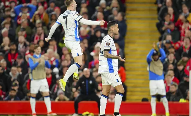 Atalanta's Gianluca Scamacca, right, celebrates scoring his side's 2nd goal during the Europa League quarter final first leg soccer match between Liverpool and Atalanta, at the Anfield stadium in Liverpool, England, Thursday, April 11, 2024. (AP Photo/Jon Super)