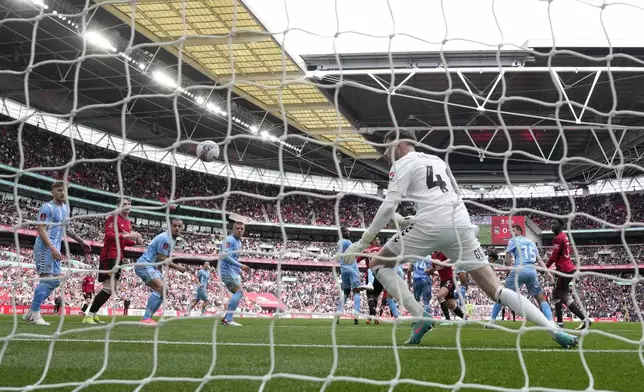 Coventry City's goalkeeper Bradley Ray Collins fails to save the goal from Manchester United's Harry Maguire during the English FA Cup semifinal soccer match between Coventry City and Manchester United at Wembley stadium in London, Sunday, April 21, 2024. (AP Photo/Alastair Grant)
