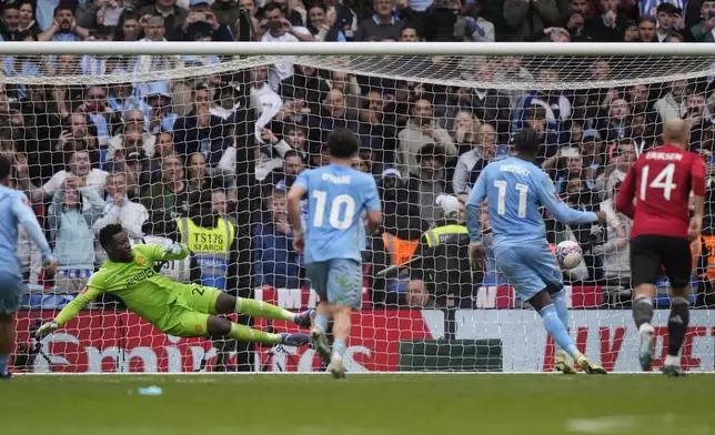 Manchester United's goalkeeper Andre Onana dives but fails to save the goal from Coventry City's Haji Amir Wright, second right, during the English FA Cup semifinal soccer match between Coventry City and Manchester United at Wembley stadium in London, Sunday, April 21, 2024. (AP Photo/Alastair Grant)