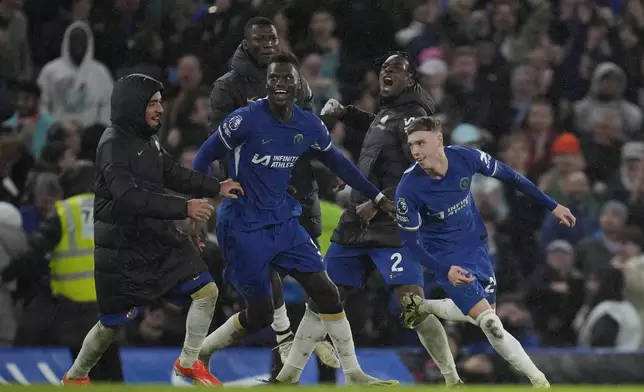 Chelsea's Cole Palmer, right, celebrates after scoring his side's third goal during the English Premier League soccer match between Chelsea and Manchester United at Stamford Bridge in London, Thursday, April 4, 2024. (AP Photo/Kin Cheung)