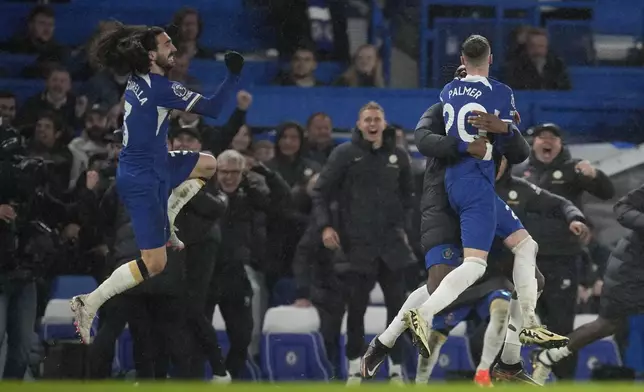 Chelsea's Cole Palmer, right, celebrates after scoring his side's fourth goal during the English Premier League soccer match between Chelsea and Manchester United at Stamford Bridge in London, Thursday, April 4, 2024. (AP Photo/Kin Cheung)