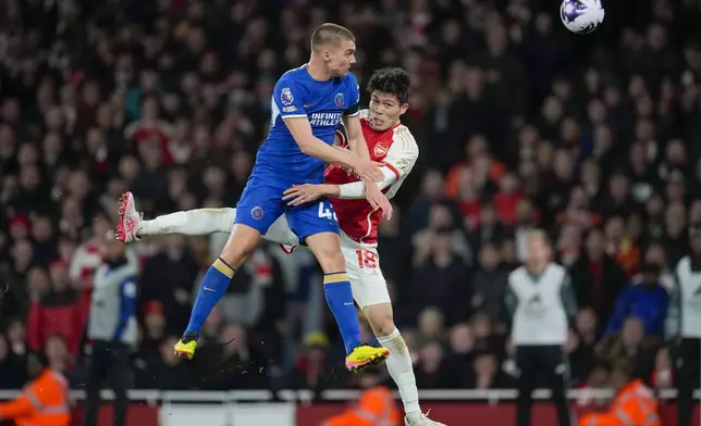 Chelsea's Alfie Gilchrist, left, jumps for the ball with Arsenal's Takehiro Tomiyasu during the English Premier League soccer match between Arsenal and Chelsea at Emirates Stadium in London, Tuesday, April 23, 2024. (AP Photo/Kin Cheung)