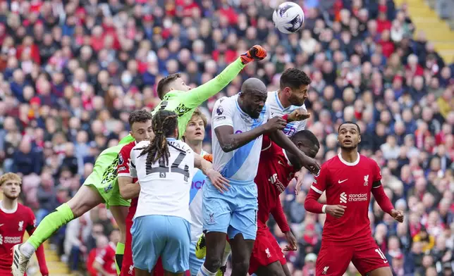 Crystal Palace's goalkeeper Dean Henderson punches the ball away during the English Premier League soccer match between Liverpool and Crystal Palace at Anfield Stadium in Liverpool, England, Sunday, April 14, 2024. (AP Photo/Jon Super)
