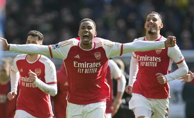 Arsenal's Gabriel celebrates with team mates at the end of the English Premier League soccer match between Tottenham Hotspur and Arsenal at the Tottenham Hotspur Stadium in London, England, Sunday, April 28, 2024. (AP Photo/Kin Cheung)