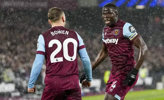 West Ham's Kurt Zouma, right, celebrates with West Ham's Jarrod Bowen after scoring his side's opening goal during the English Premier League soccer match between West Ham and Tottenham, at the London stadium in London, Tuesday, April 2, 2024. (AP Photo/Kirsty Wigglesworth)
