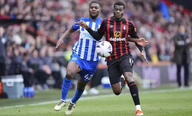 Bournemouth's Dango Ouattara, right, and Brighton and Hove Albion's Odeluga Offiah, left, challenge for the ball during the English Premier League soccer match between AFC Bournemouth and Brighton &amp; Hove Albion in Bournemouth, England, Sunday, April 28, 2024. (Adam Davy/PA via AP)