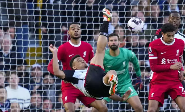 Fulham's Rodrigo Muniz, center, kicks the ball during the English Premier League soccer match between Fulham and Liverpool at Craven Cottage stadium in London, Sunday, April 21, 2024. (AP Photo/Kirsty Wigglesworth)