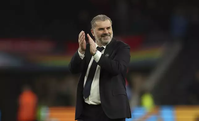 Tottenham's head coach Ange Postecoglou applauds the fan after the end of the during the English Premier League soccer match between Tottenham Hotspur and Nottingham Forrest t White Hart Lane stadium in London, Sunday, April 7, 2024. (AP Photo/Ian Walton)
