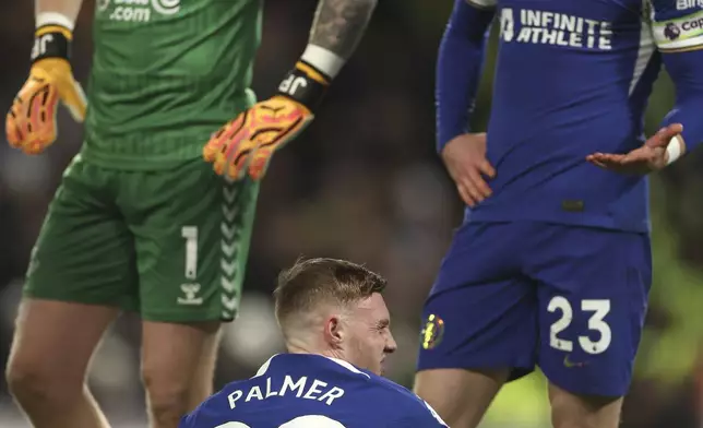 Chelsea's Cole Palmer sits on the pitch in pain during the English Premier League soccer match between Chelsea and Everton at Stamford Bridge stadium in London, Monday, April 15, 2024. (AP Photo/Ian Walton)