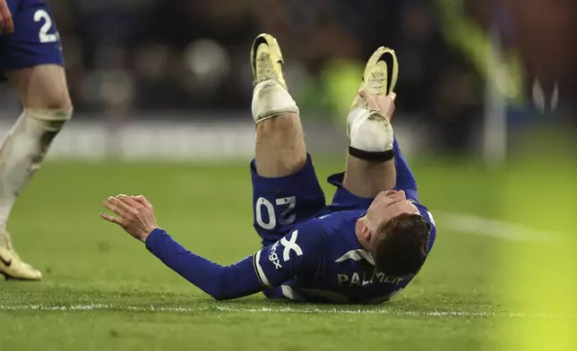 Chelsea's Cole Palmer lies on the pitch in pain during the English Premier League soccer match between Chelsea and Everton at Stamford Bridge stadium in London, Monday, April 15, 2024. (AP Photo/Ian Walton)