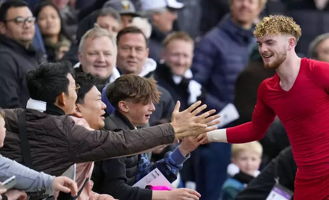 Liverpool's Harvey Elliott shakes hands with fans at the end of the English Premier League soccer match between Fulham and Liverpool at Craven Cottage stadium in London, Sunday, April 21, 2024. (AP Photo/Kirsty Wigglesworth)