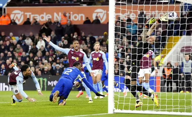 Chelsea's Axel Disasi, second left, scores their side's third goal of the game before ruled out for a foul via VAR during the English Premier League soccer match between Aston Villa and FC Chelsea in Birmingham, England, Saturday, April 27, 2024. (Nick Potts/PA via AP)