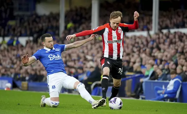 Everton's Jack Harrison, left, and Brentford's Mikkel Damsgaard, right, challenge for the ball during the English Premier League soccer match between FC Everton and FC Brentford in Liverpool, England, Saturday, April 27, 2024. (Peter Byrne/PA via AP)