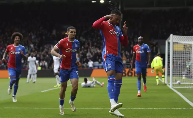 Crystal Palace's Michael Olise celebrates scoring their first goal of the game during the English Premier League soccer match between West Ham United and Crystal Palace at Selhurst Park in London, Sunday April 21, 2024. (Steven Paston/PA via AP)