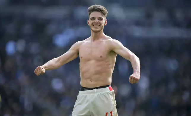 Arsenal's Declan Rice celebrates at the end of the English Premier League soccer match between Tottenham Hotspur and Arsenal at the Tottenham Hotspur Stadium in London, England, Sunday, April 28, 2024. (AP Photo/Kin Cheung)