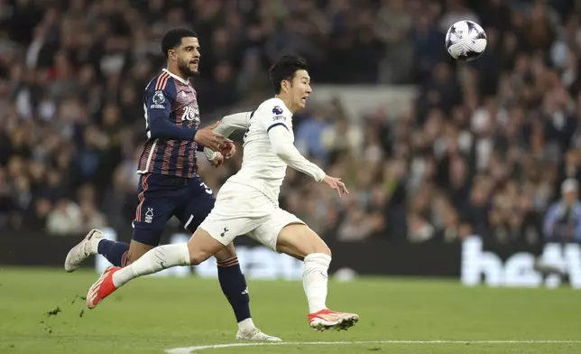 Tottenham's Son Heung-min, right vies for the ball with Nottingham Forest's Andrew Omobamidele during the English Premier League soccer match between Tottenham Hotspur and Nottingham Forrest t White Hart Lane stadium in London, Sunday, April 7, 2024. (AP Photo/Ian Walton)