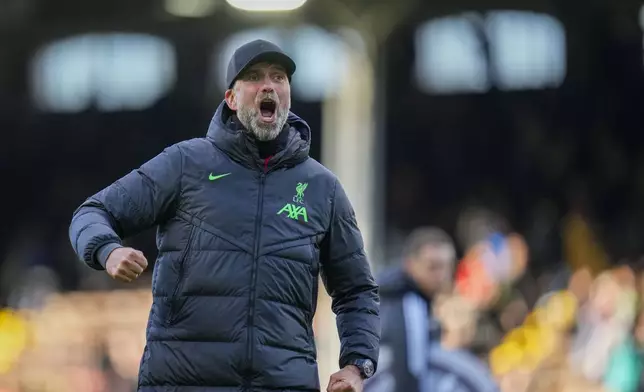 Liverpool's manager Jurgen Klopp celebrates at the end of the English Premier League soccer match between Fulham and Liverpool at Craven Cottage stadium in London, Sunday, April 21, 2024. (AP Photo/Kirsty Wigglesworth)