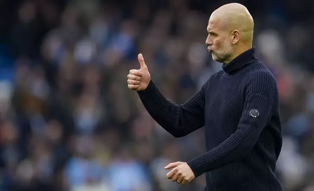 Manchester City's head coach Pep Guardiola gestures at the end of the English Premier League soccer match between Manchester City and Arsenal at the Etihad stadium in Manchester, England, Sunday, March 31, 2024. (AP Photo/Dave Thompson)