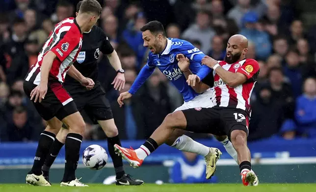 Everton's Dwight McNeil, second right, and Brentford's Bryan Mbeumo, right, challenge for the ball during the English Premier League soccer match between FC Everton and FC Brentford in Liverpool, England, Saturday, April 27, 2024. (Peter Byrne/PA via AP)
