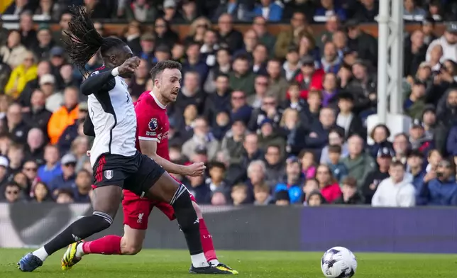 Liverpool's Diogo Jota scores his side's third goal during the English Premier League soccer match between Fulham and Liverpool at Craven Cottage stadium in London, Sunday, April 21, 2024. (AP Photo/Kirsty Wigglesworth)