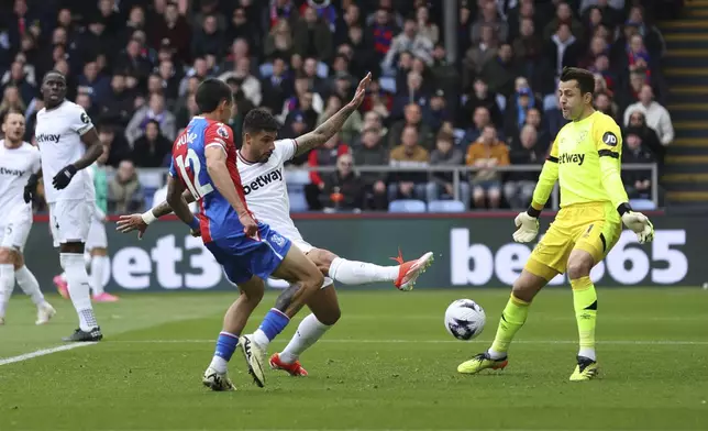 West Ham United's Emerson Palmieri, center, scores an own goal to give Crystal Palace their third goal of the game during the English Premier League soccer match between West Ham United and Crystal Palace at Selhurst Park, London, Sunday April 21, 2024. (Steven Paston/PA via AP)