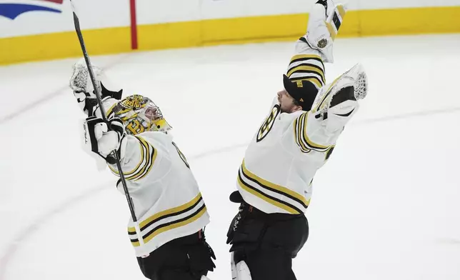 Boston Bruins goaltender Jeremy Swayman, left, and goaltender Linus Ullmark, right, celebrate after defeating the Toronto Maple Leafs in Game 4 of an NHL hockey Stanley Cup first-round playoff series in Toronto, Saturday, April 27, 2024. (Nathan Denette/The Canadian Press via AP)