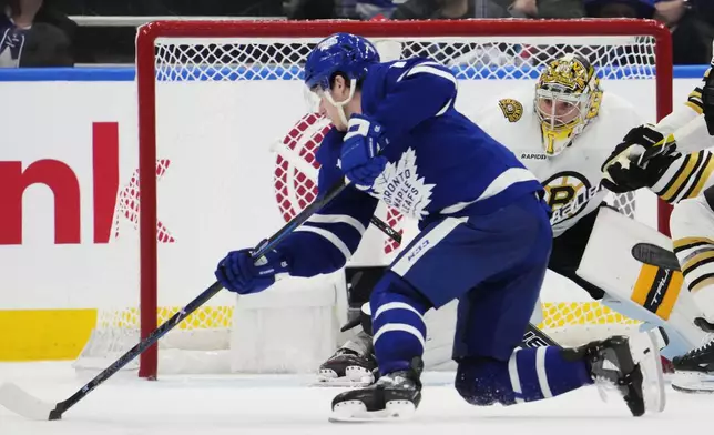 Toronto Maple Leafs' Mitch Marner (16) scores on Boston Bruins goaltender Jeremy Swayman during the third period in Game 4 of an NHL hockey Stanley Cup first-round playoff series in Toronto on Saturday, April 27, 2024. (Frank Gunn/The Canadian Press via AP)