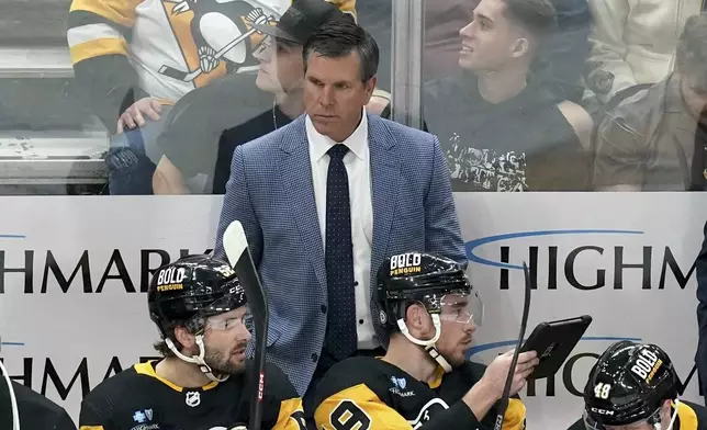 Pittsburgh Penguins coach Mike Sullivan stands behind the bench during the first period of the team's NHL hockey game against the Boston Bruins, Saturday, April 13, 2024, in Pittsburgh. (AP Photo/Matt Freed)