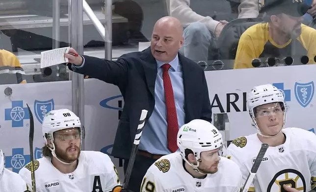 Boston Bruins coach Jim Montgomery calls out instructions to the team during the first period of an NHL hockey game against the Pittsburgh Penguins, Saturday, April 13, 2024, in Pittsburgh. (AP Photo/Matt Freed)