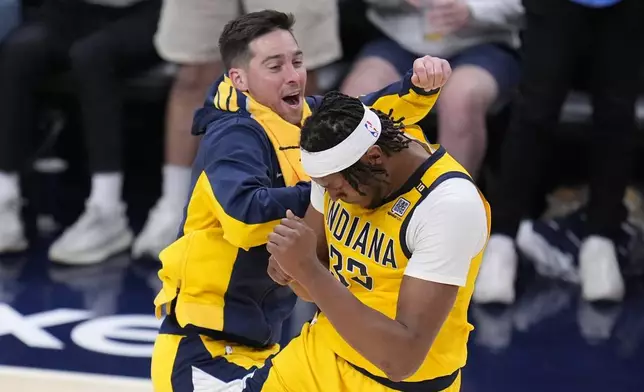 Indiana Pacers' Myles Turner celebrates with T.J. McConnell during the second half of Game 4 of the first round NBA playoff basketball series against the Milwaukee Bucks, Sunday, April 28, 2024, in Indianapolis. (AP Photo/Michael Conroy)